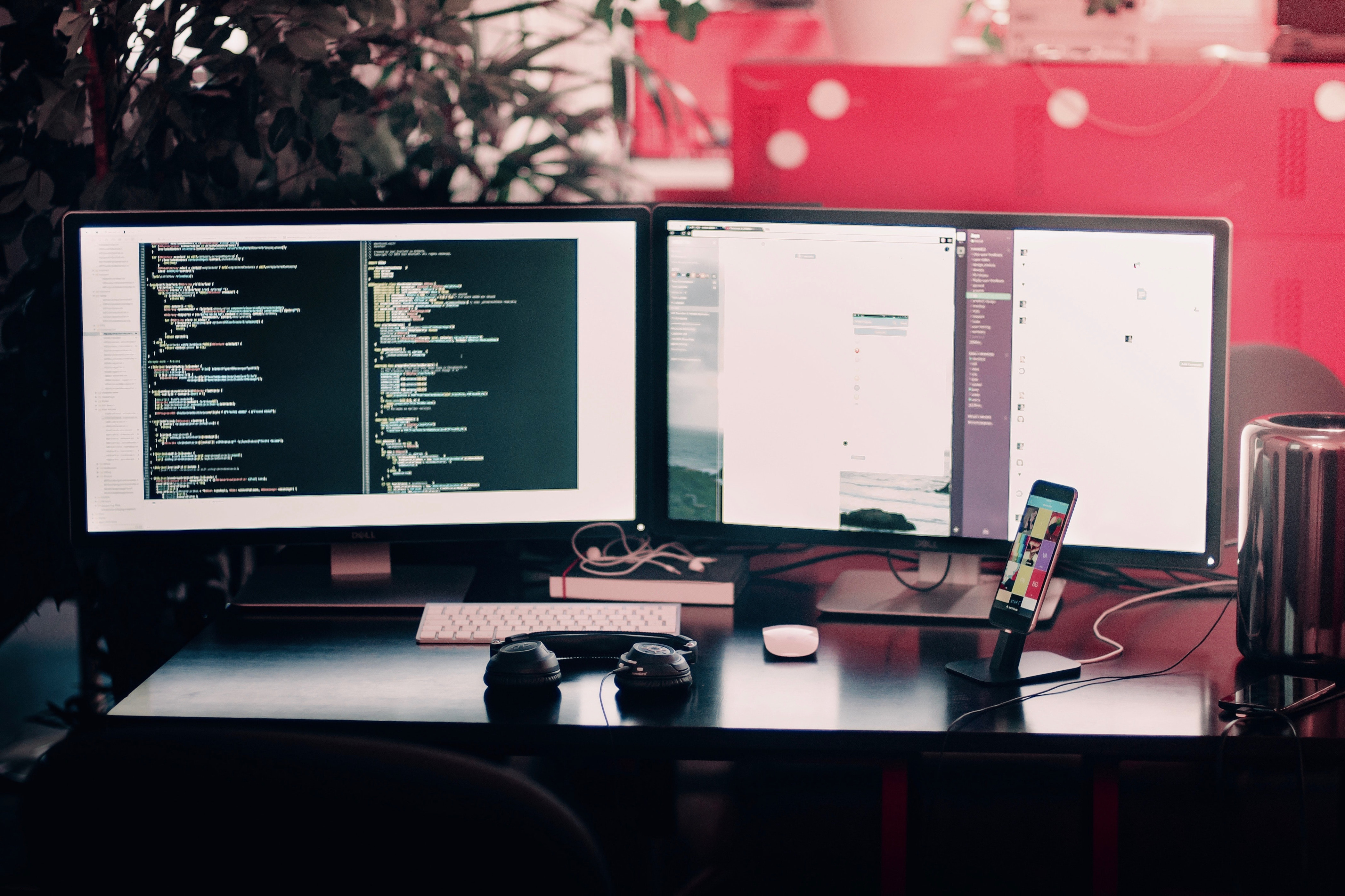 Image showing a desk with two computer monitors displaying a website alongside a code editor.